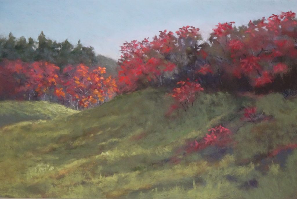 Plein air painting of vivid red sumac over grassy green hills