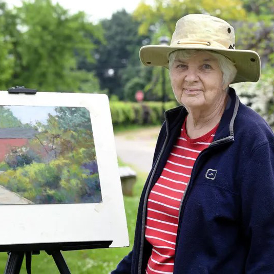 Gloria Burgoin outdoors with a plein air painting